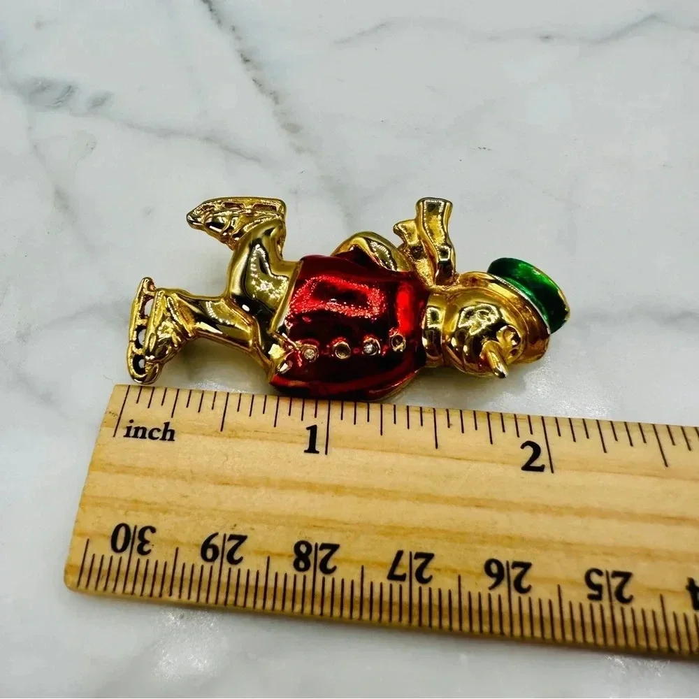 Vintage Christmas Snowman Ice Skating Brooch Pin Red Jacket Green Hat Go…